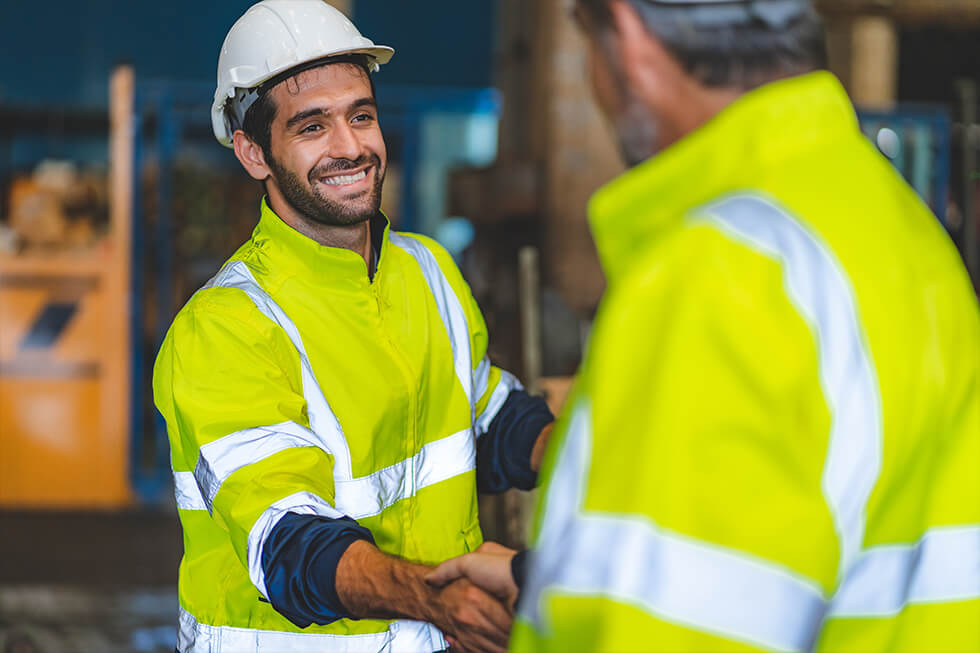 Two-men-in-yellow-jacket-shaking-hands