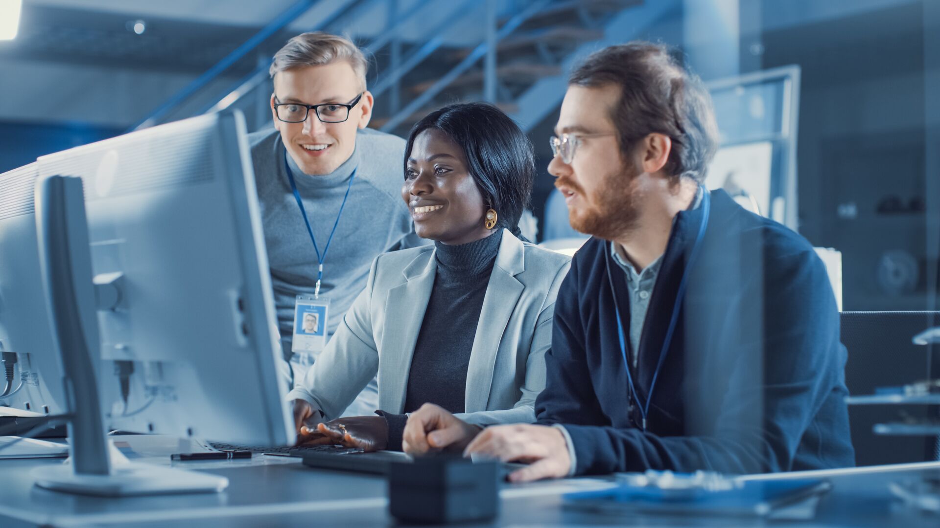 Two-men-and-a-woman-in-front-of-one-laptop